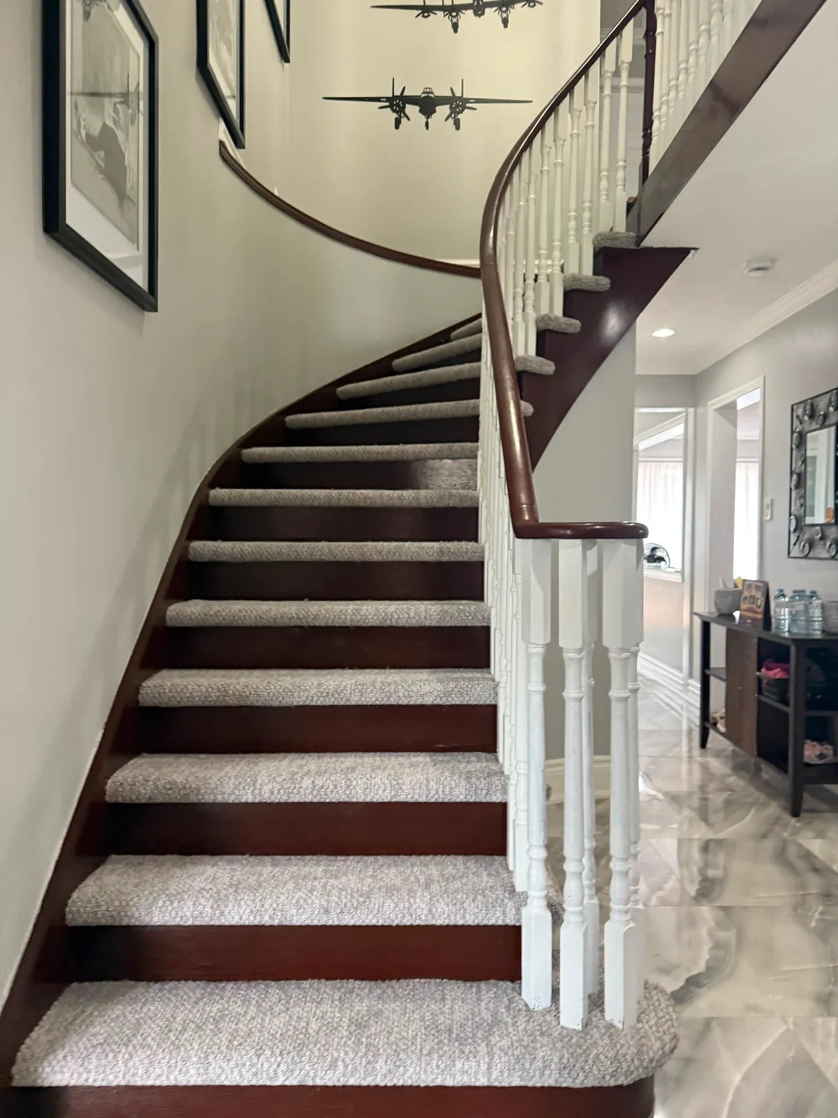 The same curved staircase seen from the hall, the inset treads following the turn up to the landing